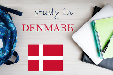 Fototapeta na wymiar Study in Denmark. Background with notepad, laptop and backpack. Education concept.