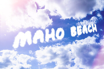 Fototapeta premium Maho beach. Text from clouds in sky in bright sunlight.