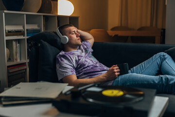 A handsome man is relaxing while listening to vinyl music