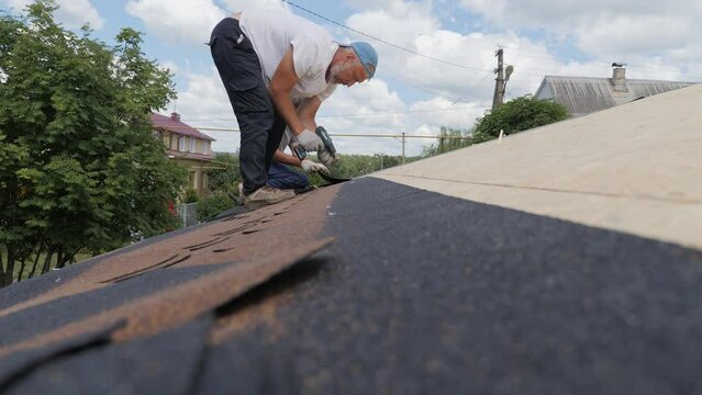 Laying of a soft roof. Construction works at height.