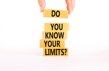 Do you know your limits symbol. Concept words Do you know your limits on wooden block. Beautiful white table white background. Businessman hand. Business do you know your limits concept. Copy space.