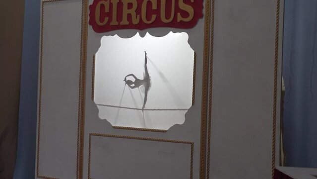 Shadow puppet theater for children. Close-up silhouette of a shadow doll during a traditional performance. Ballet dancer.