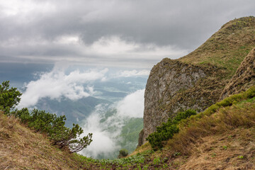 Fototapeta na wymiar Rocks and valley under Maly Krivan, view from path to mountain Maly Krivan , national park Mala Fatra, Slovakia, spring cloudy day.