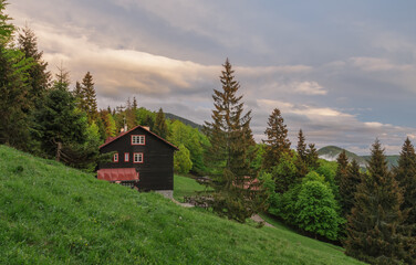 Chalet under mountain Suchy Vrch, national park Mala Fatra, Slovakia, spring sunset time