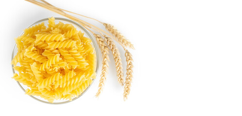 Pasta and wheat spikelets isolated on white background, banner, header, template with copy space. Raw pasta fusilli, ingredient for cook, traditonal italian cuisine. Flat lay, top view