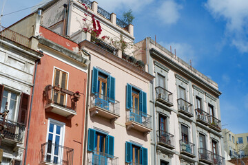 Fototapeta na wymiar Classical vintage facades with colourful windows and balconies downtown Cagliari, Sardinia island, Italy
