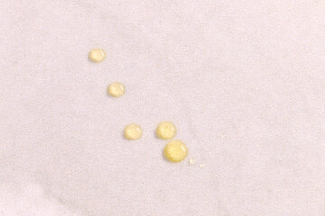 Fototapeta na wymiar Olive oil drops on white kitchen table