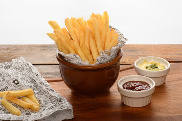 a bowl with a portion of fries mstarda sauce and katcup, on a white background