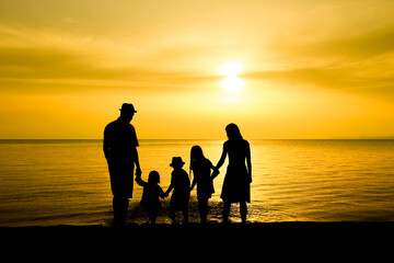 A happy family in nature by the sea on a trip silhouette