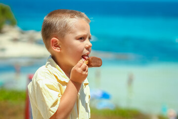 A Happy child boy with ice cream by the sea in nature in the park journey