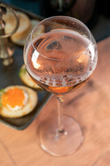 Tasting of rose brut Champagne sparkling wine with red caviar in cellars of gran cru wine house in Epernay, wine tour in Champagne, France