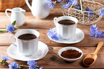 Healing drinks. Chicory drink. Cup of chicory drink and flowers on a table
