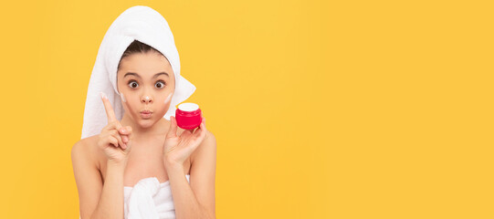 Clean skin care of teenager girl, amazed teen girl in shower towel apply facial cream. Cosmetics and skin care for teenager child, poster design. Beauty kid girl banner with copy space.