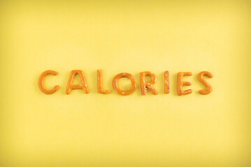 The word calories is lined with cookies on a yellow background.