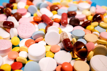 Fototapeta na wymiar Background with the many colorful different capsules and pills. The concept of medical treatment