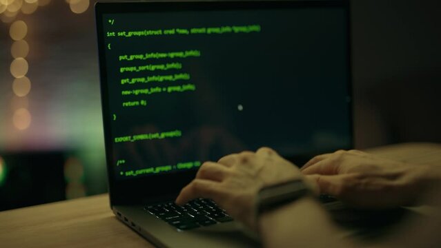 Close up of developing programming and coding technologies. Programmer hands are typing on keyboard. Software coder or blockchain developer at night. Concept of bitcoin cryptocurrency and wallet hack