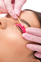 Make-up artist makes the procedure of lamination and dyeing of eyelashes to a beautiful woman in a...
