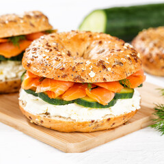 Bagel sandwich with salmon and cream cheese for breakfast on a kitchen board square