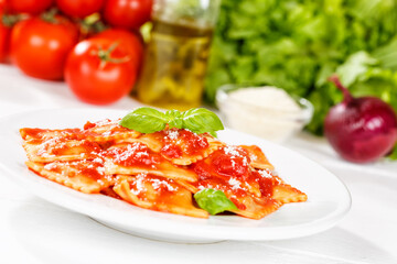 Ravioli pasta meal from Italy for lunch dish with tomato sauce on a plate