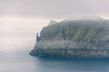 View from the Sornfelli mountain in Faroe Islands to the famous Trollkonufingur, witchs finger on Vagar island, Denmark, Northern Europe