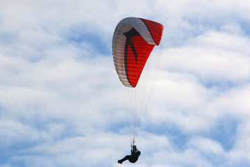 Paraglider flying in a blue sky	