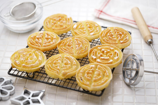 rosette cookies( circle ) on a cake cooling rack