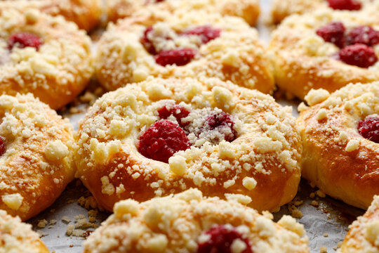 Homemade sweet  yeast buns with raspberries and butter crumble, focus on the bun inside
