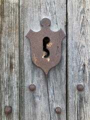 Weathered wooden door and rusty keyhole, Ragusa, Sicily