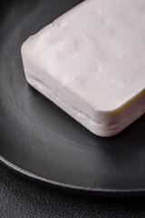 Delicious fresh rectangular shaped feta cheese with spices and vegetables