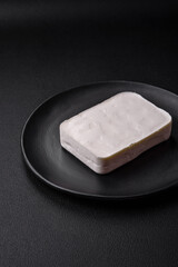 Delicious fresh rectangular shaped feta cheese with spices and vegetables