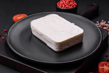 Delicious fresh rectangular shaped feta cheese with spices and vegetables