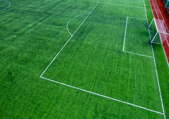 Penalty area top view in soccer field. Green football carpet field. Drone shot.