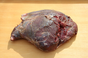 raw Roe wild meat on a wooden board