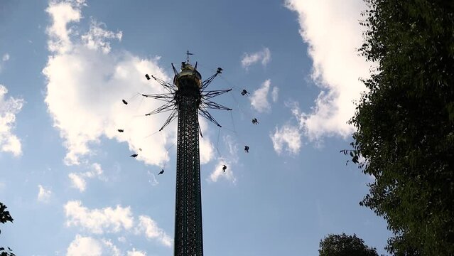 Flying Swing in Amusement Park in Vienna. Bellow View of Fun Attraction in Austria. 