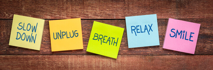 Self care and healthy lifestyle concept, a set of colorful reminder notes on rustic wood: slow...