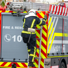 Fototapeta premium firefighter man works on his fire truck. fire safety service