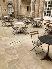 Outdoor cafe in old courtyard, Ortigia, Sicily