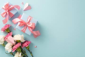 Mother's Day concept. Top view flat lay photo of gift boxes with pink ribbons, carnation flowers,...