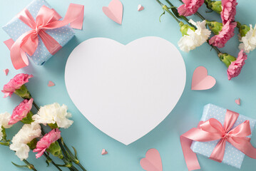 Mother's Day love concept. Top view flat lay photo of beautiful present boxes with pink ribbons, carnation flowers, and pink paper hearts on pastel blue background with empty heart for text