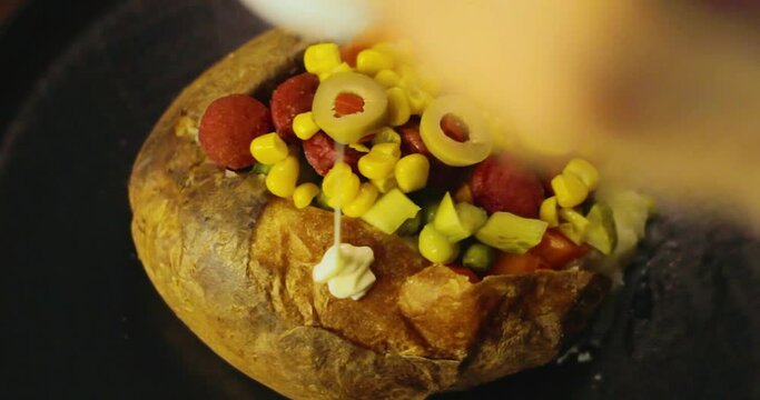 To prepare kumpir, green olives are added to the potato and mayonnaise, ketchup is squeezed