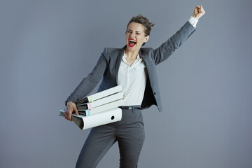 smiling stylish business owner woman rejoicing isolated on gray