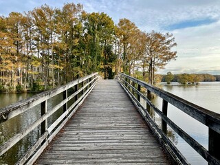 Wooden bridge over a lake at sunset