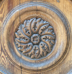 Ornate carved medallion on wooden door, Scicli, Sicily