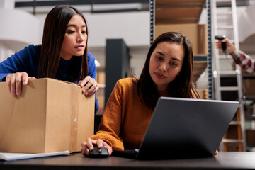 Storehouse asian workers doing parcel quality control and managing delivery. Ecommerce retail...
