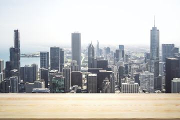 Blank wooden tabletop with beautiful Chicago skyline at daytime on background, mockup