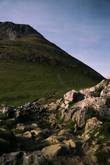 The landscape of the green mountain peak in summer. Rocky cliff.