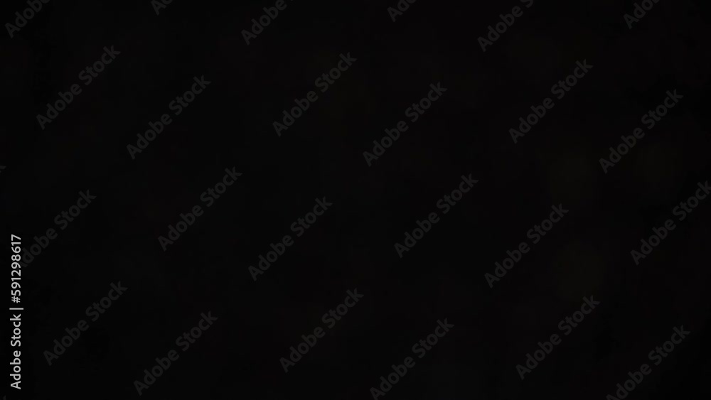 Wall mural flashing silver bokeh lights on black. abstract moving background, overlay or video transition. fast