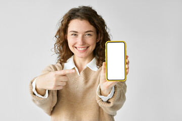 Young happy woman model pointing at big mobile phone screen presenting new trendy app at cell, showing blank empty display cellphone template, holding smartphone mock up isolated on white background.