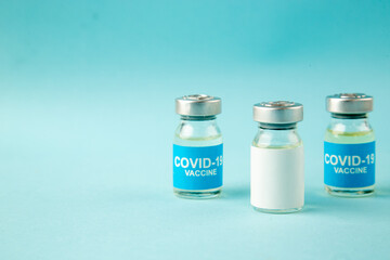 front view little vaccines in cans on a blue background virus illness color health pandemic covid-
