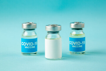 front view little vaccines in cans on blue background virus illness color health pandemic covid-